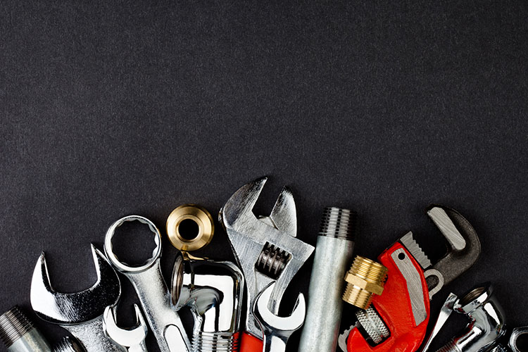 plumbers-tools plumber's tools lined up on table